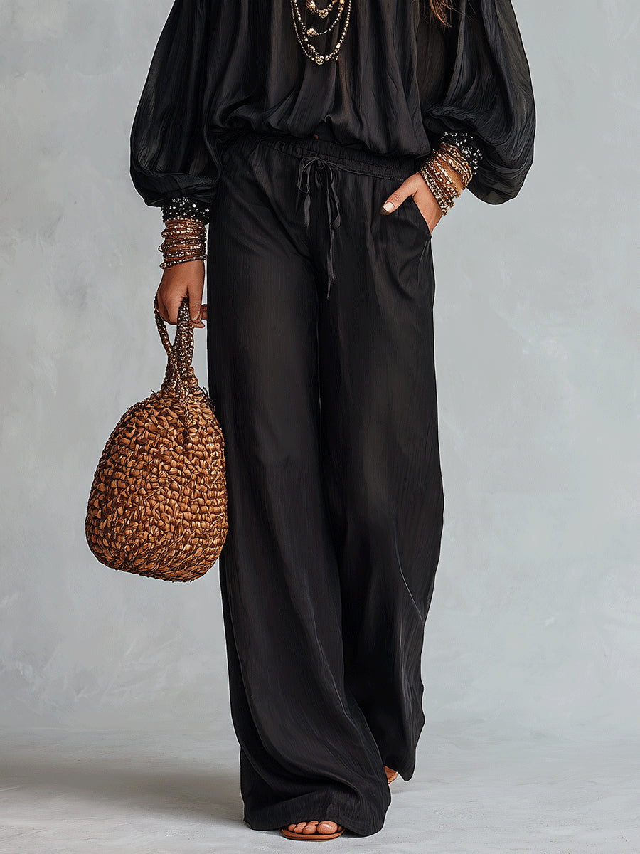 Daria | Conjunto de top negro con hombros al aire y lentejuelas y pantalón ancho con cordón