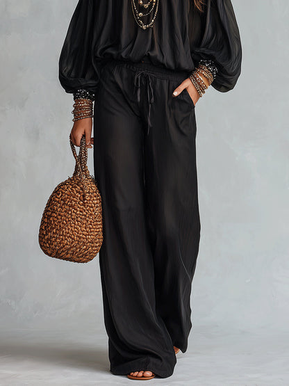 Daria | Conjunto de top negro con hombros al aire y lentejuelas y pantalón ancho con cordón
